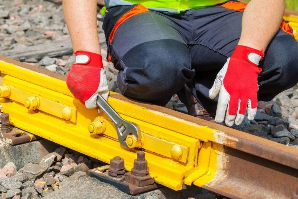 Railway engineer maintaining railway tracks